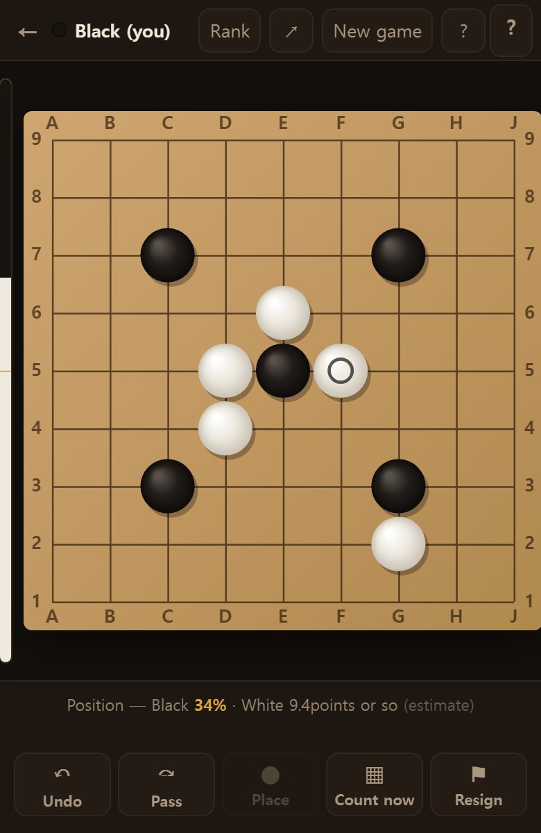 A few moves into a nine-line board. Stones sit on the points where the lines cross.