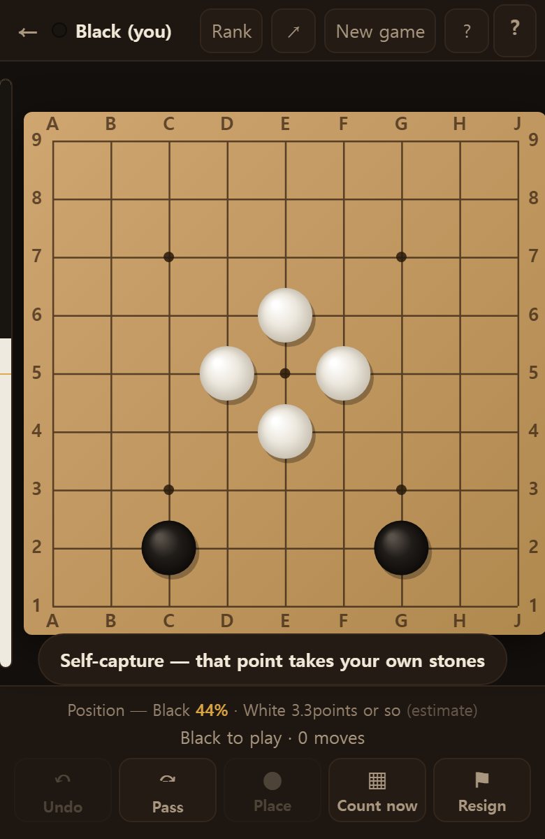 You may not play into a point surrounded by white. It tells you that is self-capture.